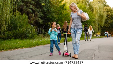 Mother And Daughter Walking Along Path Royalty-Free Stock Photo #714723637