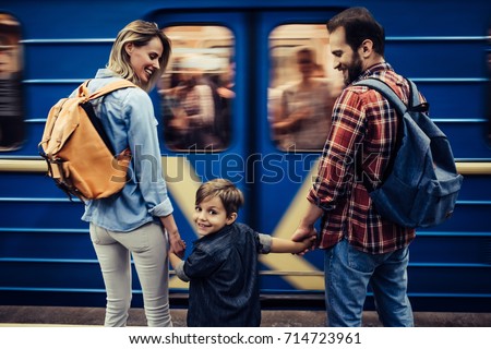 Couple of tourists with their little cute son is exploring new city together. Underground. Royalty-Free Stock Photo #714723961