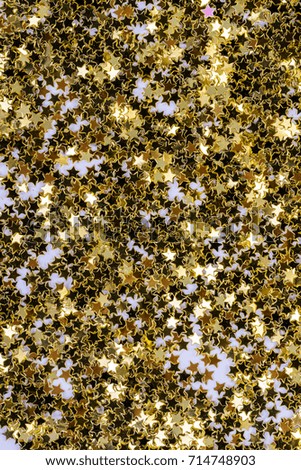 Abstract art background of glitter gold confetti stars. Perfect for disco, celebration, holidays like Christmas, New Year and any other.