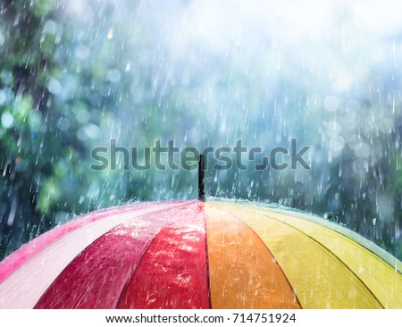 Rain On Rainbow Umbrella Royalty-Free Stock Photo #714751924