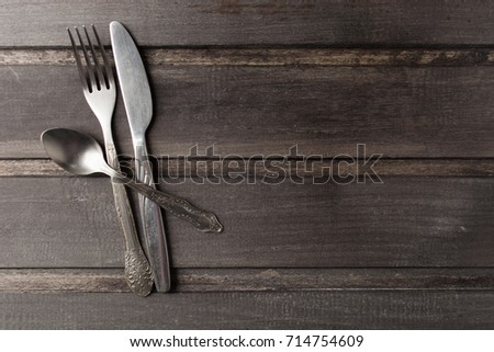 Serving table with rustic style and retro flatware over wooden background with copy space