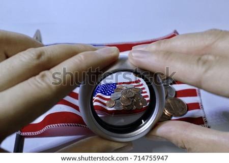 Coins (USD) currency money over the flag of the United States.