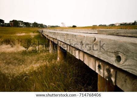 Eye level shot of a wooden bridge edited to give a warm feeling. 