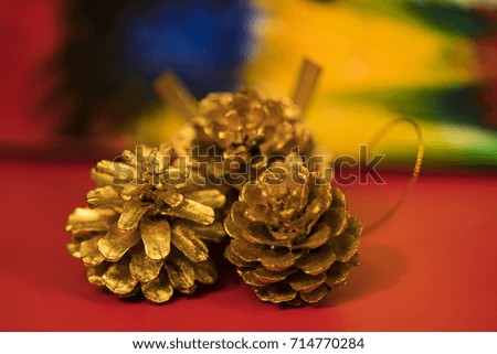Golden pine cones on colorful background for Christmas decoration./ Christmas decoration.