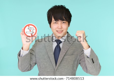 Man holds non smoking sign