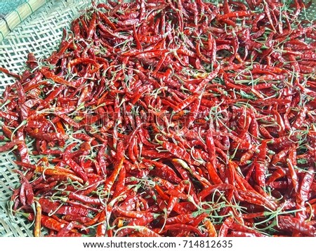 Dried Chili Peppers Bamboo Basket on wooden table,close up dried chili in basket/close up red dried chili,Dried red chills spices of Thailand.Blur picture