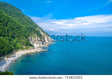 Scenery of bay consist of blue ocean, rock, mount and blue sky  with cloud