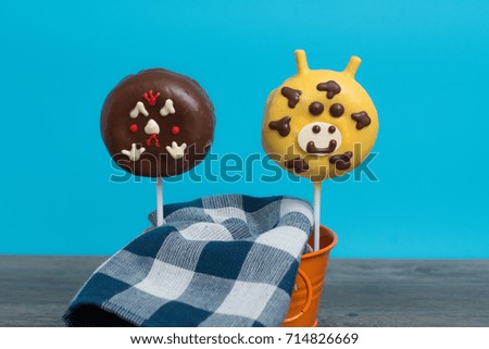 Two animal face donut sticks for kids in blue background
