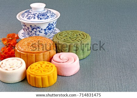Moon cake (Yuebing) for mid autumn festival (Zhongqiujie), Chinese traditional pastry : Colorful moon cake with tea. Copy space / Space for texts