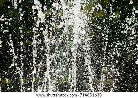Jets of water fountain, blurry background, abstraction