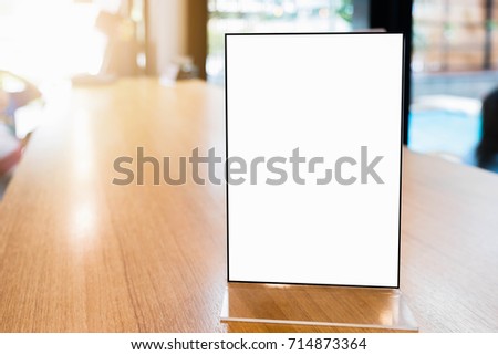 Mock up Menu frame in Bar restaurant ,Stand for booklets with white sheets of paper acrylic tent card on wooden table on.