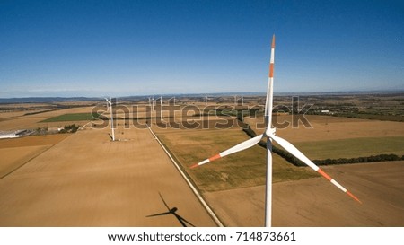 Sustainable energy, windmill farm aerial on the field stock photo.