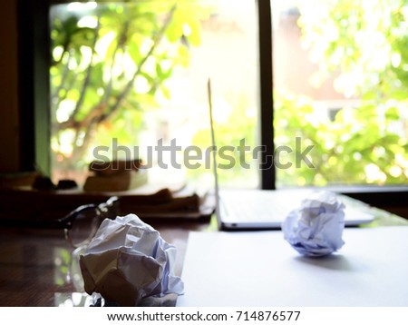 No work No money and No food. The picture of failed work condition consist of disastrously paper, white laptop, pencil, glasses, and  hand above wooden table. selective focus