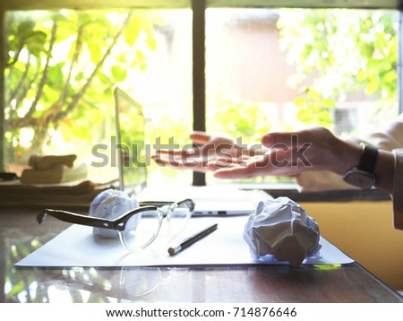 No work No money and No food. The picture of failed work condition consist of disastrously paper, white laptop, pencil, glasses, and  hand above wooden table. selective focus
