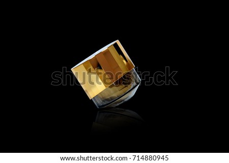 Gold cream cartridges on a black backdrop
