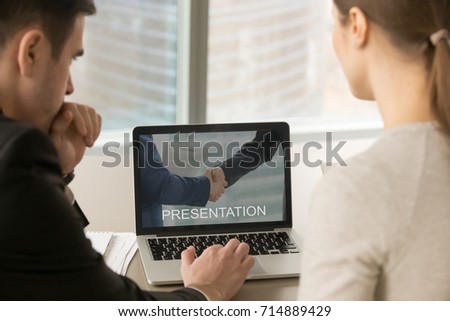 Businesspeople looking at computer presentation on laptop screen at meeting, business team preparing slide show about company achievements as collaboration offer, close up rear view