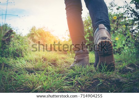 hiking shoes in action on a mountain desert trail path. Close-up of female hikers shoes.
 Royalty-Free Stock Photo #714904255