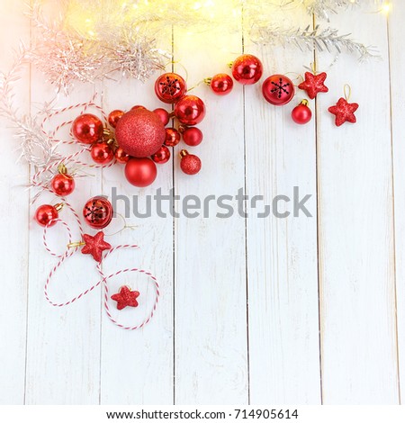 Christmas red balls and garland on white wooden rustic table. winter festive season. Christmas holiday background. top view. copy space. template for design