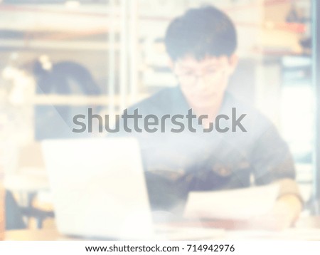 Blurred image, Young designer or business start up hand working with computer laptop on workplace in office, lifestyle man and technology communication