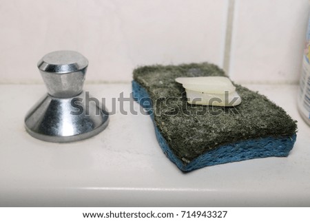 sponge with bar of soap on a sink 