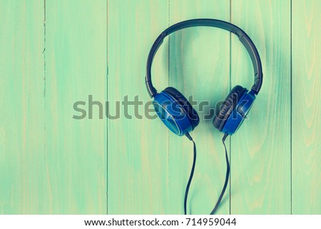 Stereo headphones on wooden background with copy-space