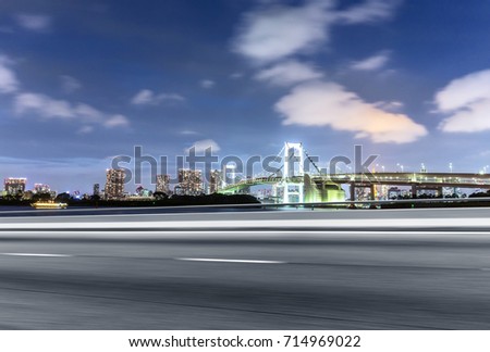 blurred empty asphalt road and cityscape of sydney at twilight in blue sky
