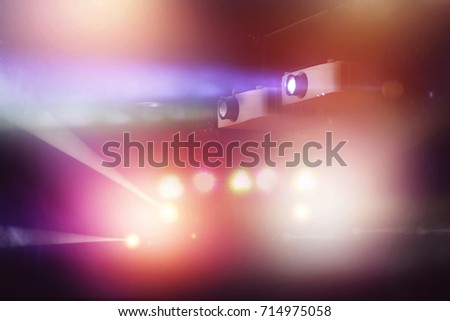 video projector in nightclub and colorful light beam