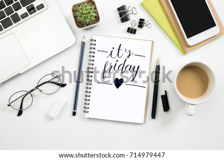 Notebook with it's friday calligraphy text is on top of white office desk table. Top view, flat lay. Royalty-Free Stock Photo #714979447