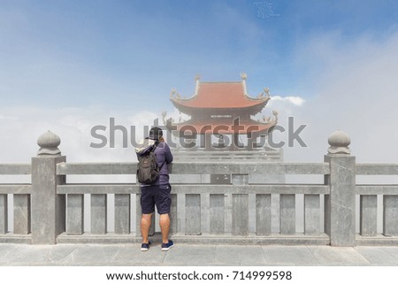 The tourist take a photo of temple and a lot of mist or fog in Sapa, Vietnam