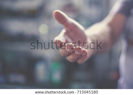Senior worker provides hand. Close up. Royalty-Free Stock Photo #715045180