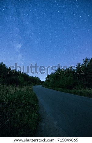 Empty night road with lot of stars in the sky