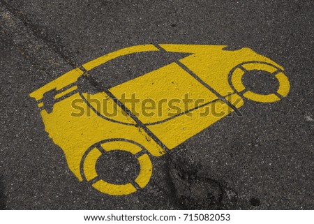 parking spot with a yellow car painted.