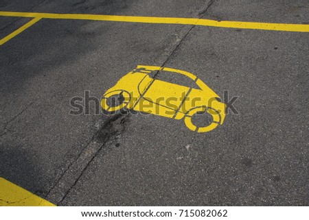 parking spot with a yellow car painted.