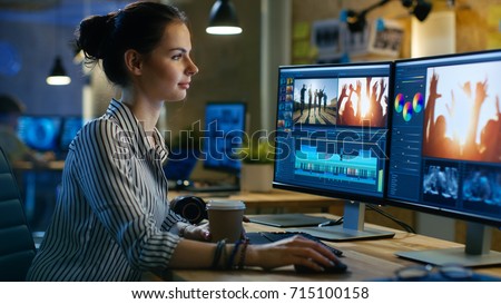 Beautiful Female Video Editor Works with Footage on Her Personal Computer, She Works in Creative Office Studio. Royalty-Free Stock Photo #715100158