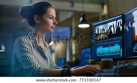 Female Video Editor Works with Footage and Sound on Her Personal Computer. She Works Late. Her Office is Modern and Creative Loft Studio.