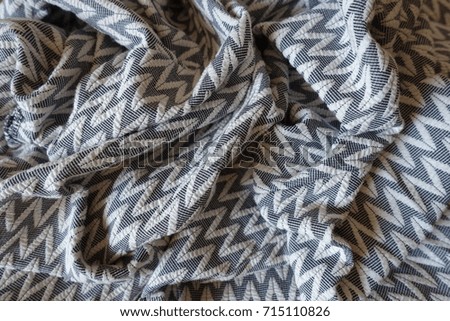 Thick gray patterned fabric in soft folds