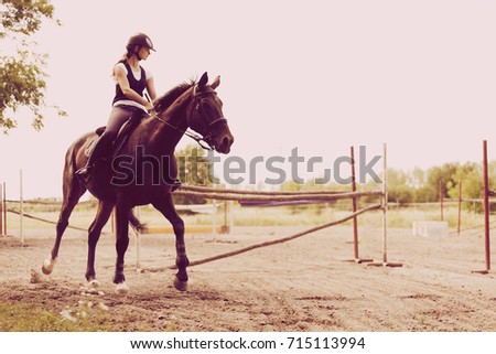 Picture of young girl riding her horse
