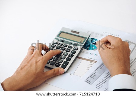 Close up asian business man using a calculator to calculate the numbers.Business finances and accounting concept

