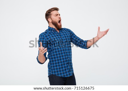 Young attractive bearded man singing loud while standing isolated over white background Royalty-Free Stock Photo #715126675