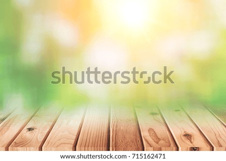 wood floor with blur green trees of nature park background