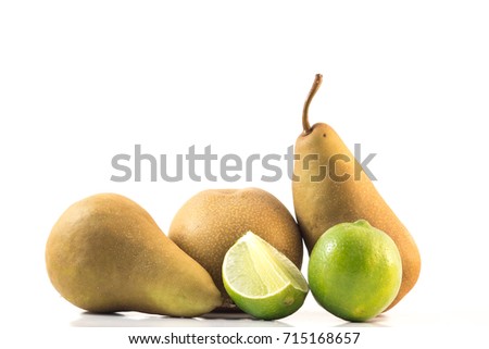 Brown Bosc pear, asian pear and green lime isolated on white