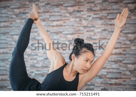 Yoga girl in class fitness wear black clothes in the brick wall 
