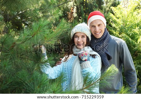 Young happy couple at Christmas tree market