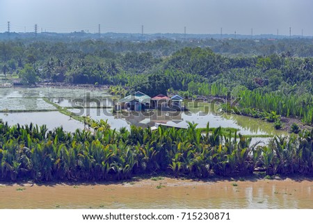 Rural scenery with houses, river, vegetation on Long Tau (Song Long Tau) river banks in suburb of Ho Chi Minh City (Saigon) in Vietnam.