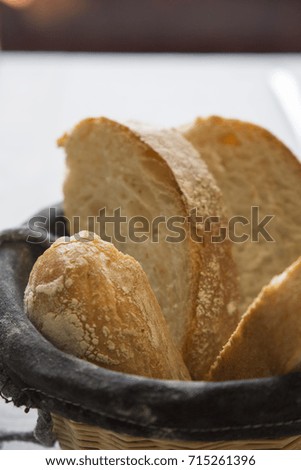 Basket in black with bread slices on table restaurant Spain