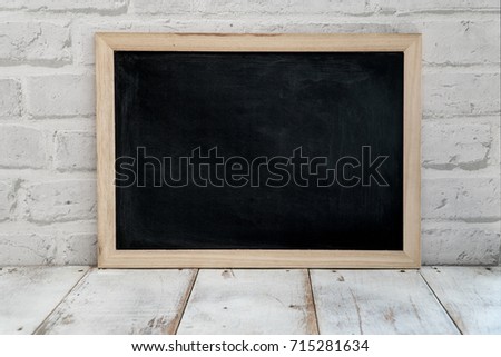 empty blackboard on old wood table or panel,old school design decoration,blank space blackboard mock up.