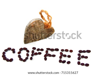 Wooden heart with coffee word made from beans isolated on white background
