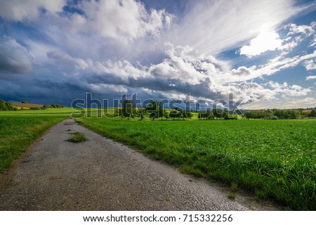 Cloudy, stormy summer day at some green fields