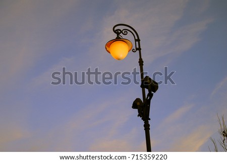 Vintage style street light in Moscow Kremlin. Color evening photo. Blue sky background.