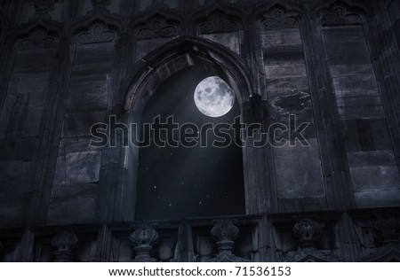 Full moon seen through the window of the old castle